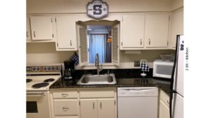 Kitchen with white cabinets and white appliances