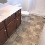 a white toilet sitting next to a bath tub in a bathroom