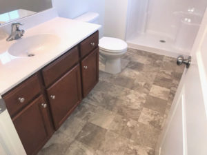 a white toilet sitting next to a bath tub in a bathroom