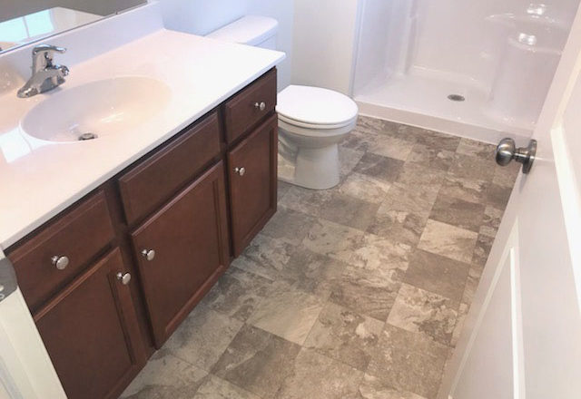 a white toilet sitting next to a bath tub in a bathroom