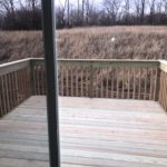 a wooden deck in front of a sliding glass door