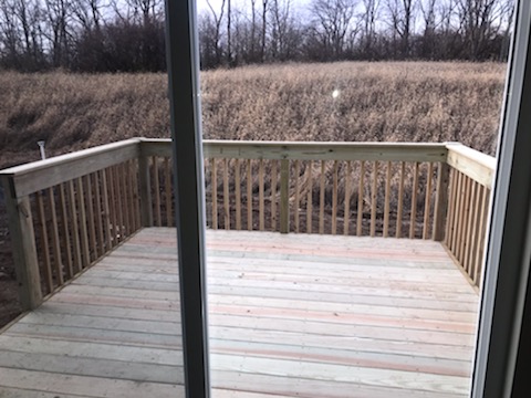 a wooden deck in front of a sliding glass door