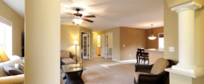 a living room filled with furniture and a ceiling fan