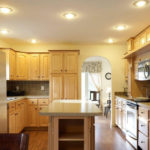 a kitchen with wooden cabinets and white appliances