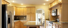 a kitchen with wooden cabinets and white appliances