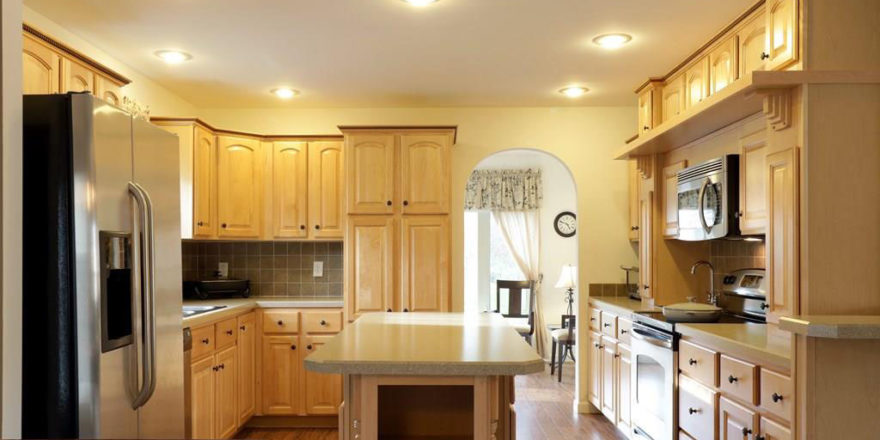 a kitchen with wooden cabinets and white appliances