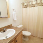a white toilet sitting next to a bathroom sink
