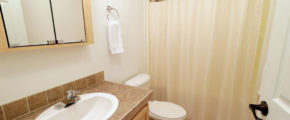 a white toilet sitting next to a bathroom sink