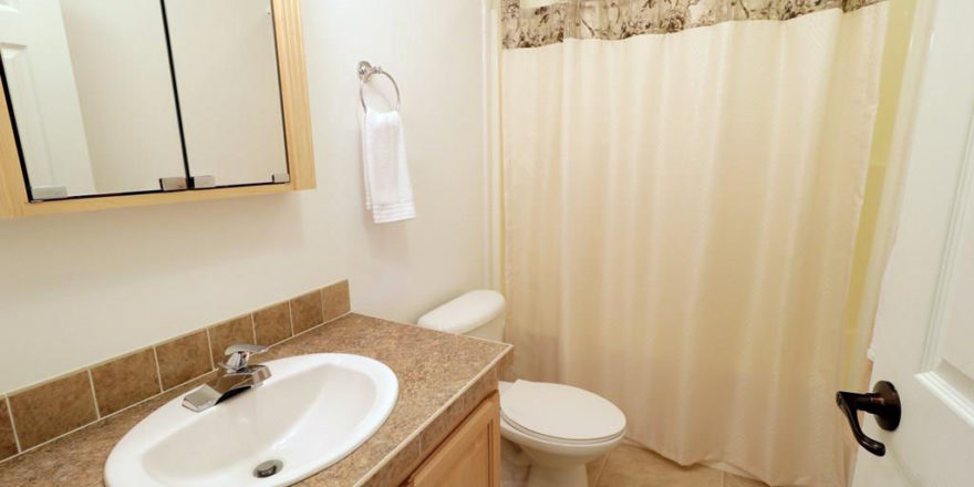 a white toilet sitting next to a bathroom sink