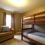 a living room with a couch and bunk beds