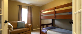 a living room with a couch and bunk beds