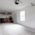 an empty room with a ceiling fan and a fire place