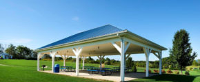 a covered picnic area with benches and tables