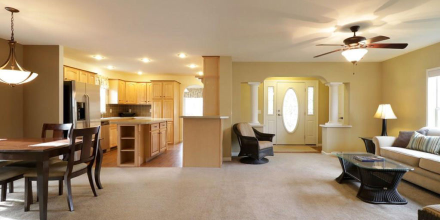 an empty living room and dining room in a house