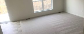 an empty room with carpeted floors and a window