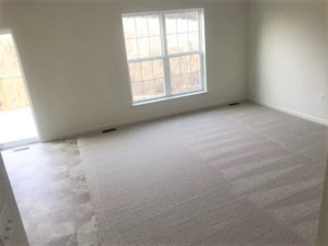 an empty room with carpeted floors and a window