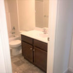 a white toilet sitting next to a bathroom sink