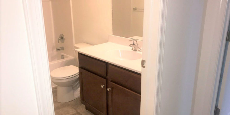 a white toilet sitting next to a bathroom sink