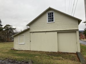 a yellow building with a large garage in front of it