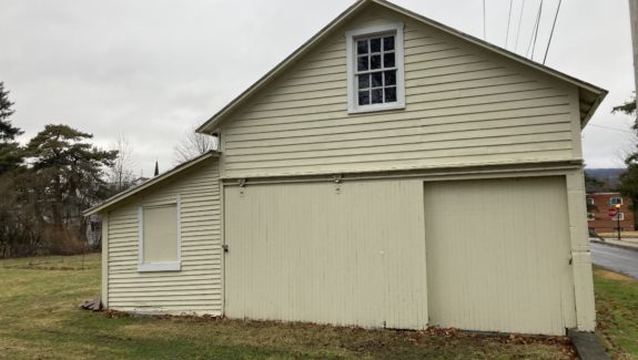 a yellow building with a large garage in front of it