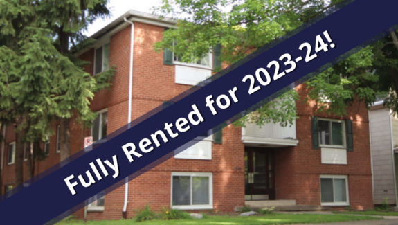 Exterior of building with a blue banner stating the property is fully rented for the 2023-2024 term
