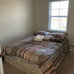 a bedroom with a bed and window in it