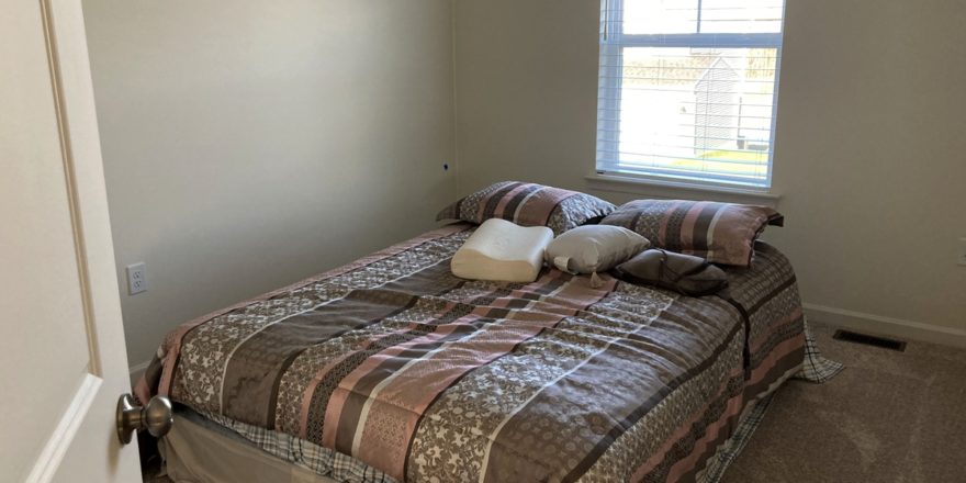 a bedroom with a bed and window in it