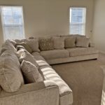 a well-lit living room filled with furniture and windows