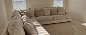 a well-lit living room filled with furniture and windows