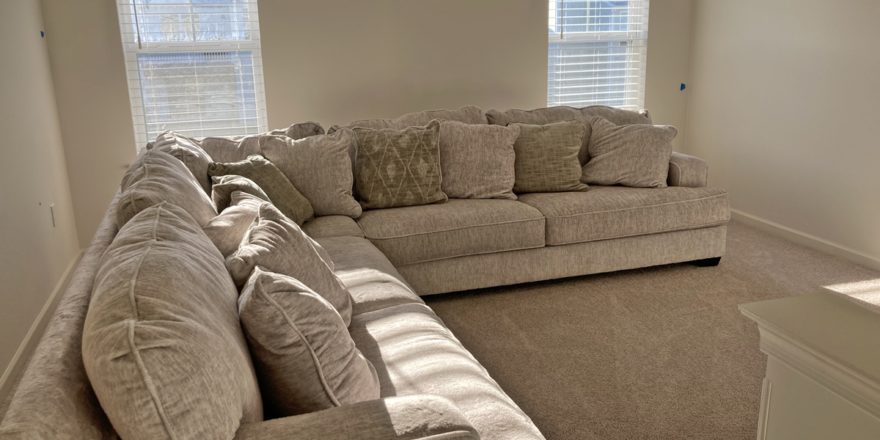 a well-lit living room filled with furniture and windows