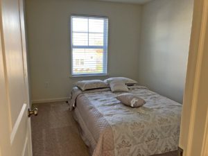 a bedroom with a bed and a window