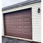 a garage door with a light on the side