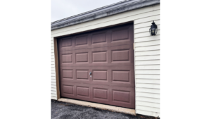 a garage door with a light on the side