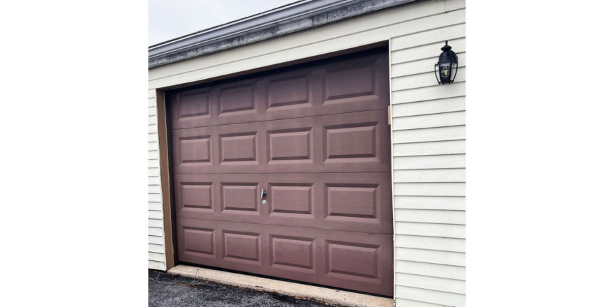 a garage door with a light on the side