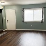 an empty living room with hard wood floors