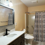 a bathroom with a shower, toilet and sink