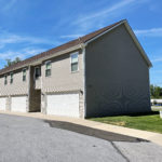 two story townhouse building with garages on each side