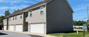 two story townhouse building with garages on each side