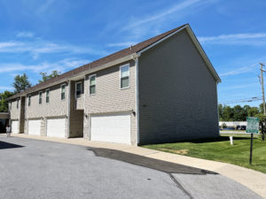 two story townhouse building with garages on each side