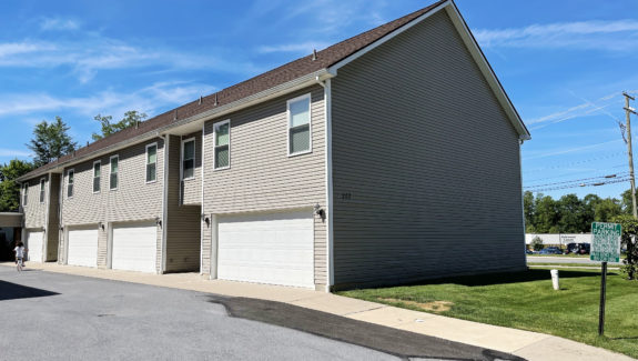 two story townhouse building with garages on each side