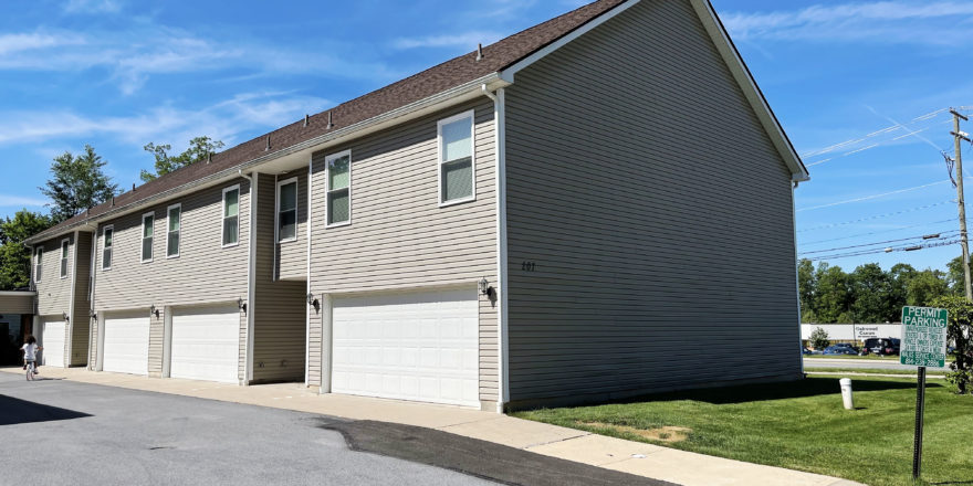 two story townhouse building with garages on each side