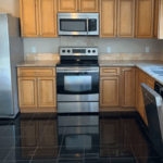 a kitchen with stainless steel appliances and wood cabinets
