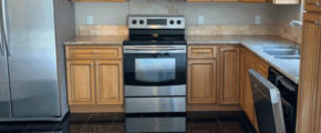 a kitchen with stainless steel appliances and wood cabinets