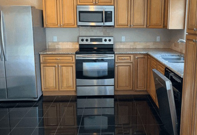 a kitchen with stainless steel appliances and wood cabinets