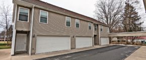 two story townhouse building with garages on each side