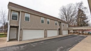 two story townhouse building with garages on each side