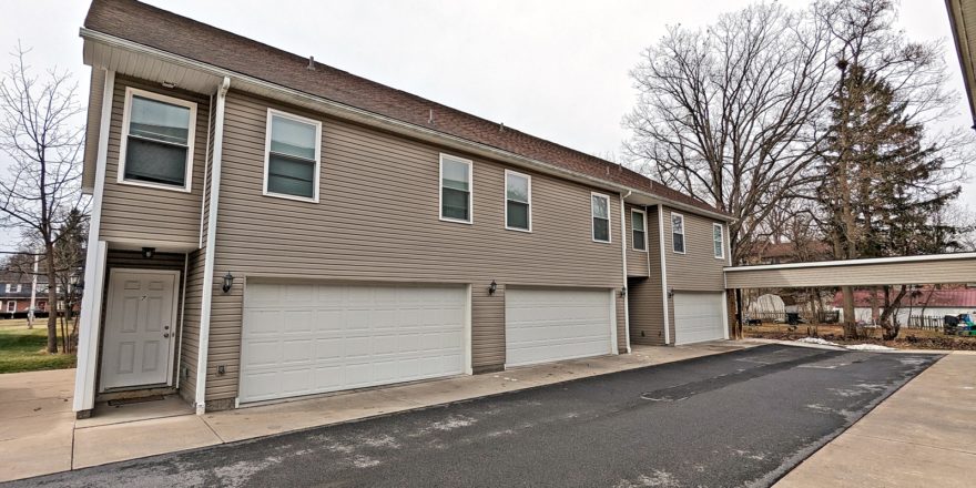 two story townhouse building with garages on each side