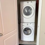 a stacked washer and dryer in a closet