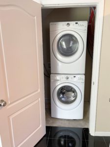 a stacked washer and dryer in a closet