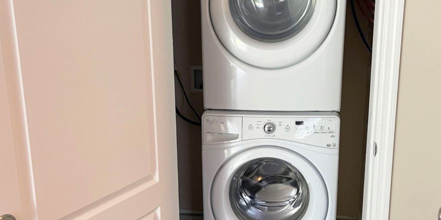 a stacked washer and dryer in a closet